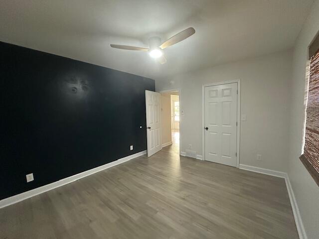 2327 Horsepasture Price Rd, Ridgeway, VA 24148 - unfurnished bedroom featuring wood finished floors and ceiling fan