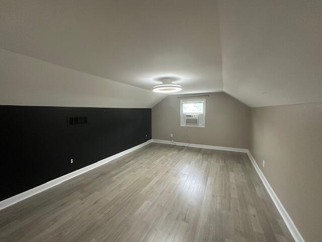 2327 Horsepasture Price Rd, Ridgeway, VA 24148 - additional living space with wood finished floors, vaulted ceiling, and cooling unit