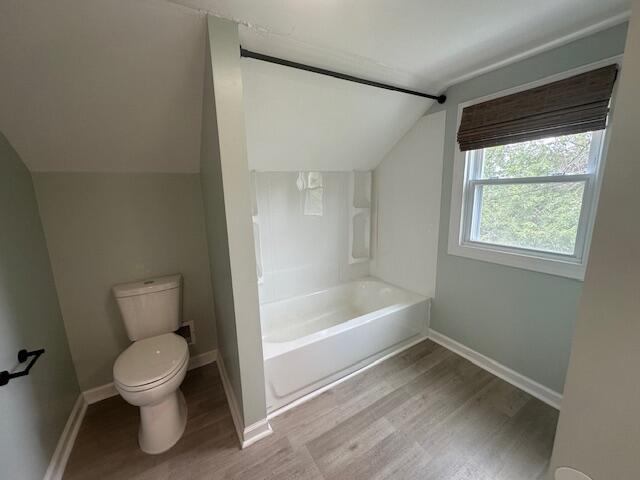 2327 Horsepasture Price Rd, Ridgeway, VA 24148 - full bathroom featuring lofted ceiling, wood finished floors, and shower / washtub combination