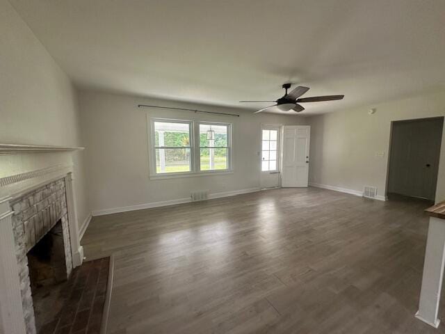 2327 Horsepasture Price Rd, Ridgeway, VA 24148 - unfurnished living room with a brick fireplace, ceiling fan, and dark wood-style flooring