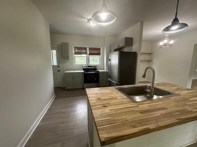 2327 Horsepasture Price Rd, Ridgeway, VA 24148 - kitchen featuring appliances with stainless steel finishes, wood counters, dark wood-type flooring, and hanging light fixtures
