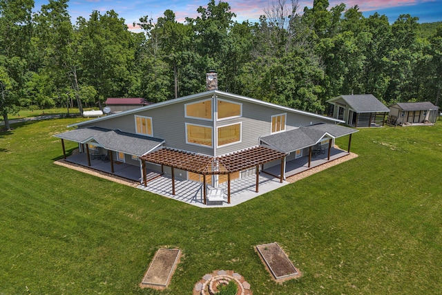 571 Cary Rd, Pilot, VA 24138 - rear view of house with a patio, a chimney, a yard, and an outdoor structure