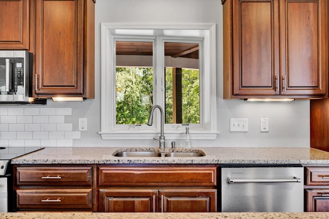 571 Cary Rd, Pilot, VA 24138 - kitchen featuring stainless steel appliances, decorative backsplash, light stone countertops, and brown cabinets