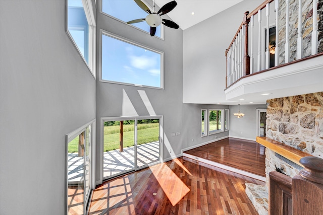 571 Cary Rd, Pilot, VA 24138 - staircase with high vaulted ceiling, wood-type flooring, ceiling fan, and a chandelier