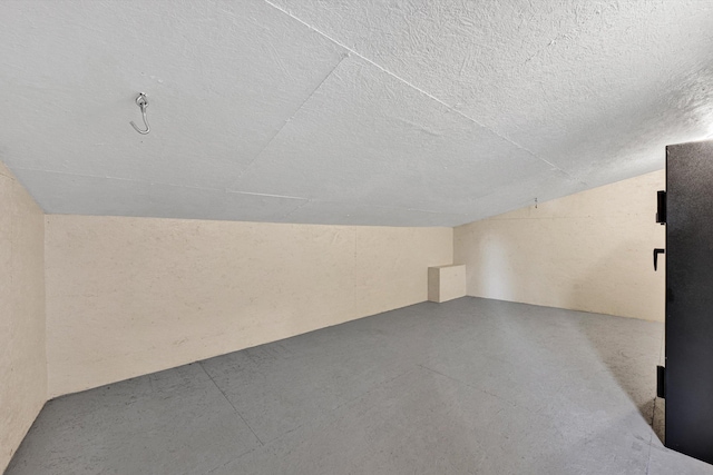 571 Cary Rd, Pilot, VA 24138 - additional living space featuring finished concrete flooring, vaulted ceiling, and a textured ceiling