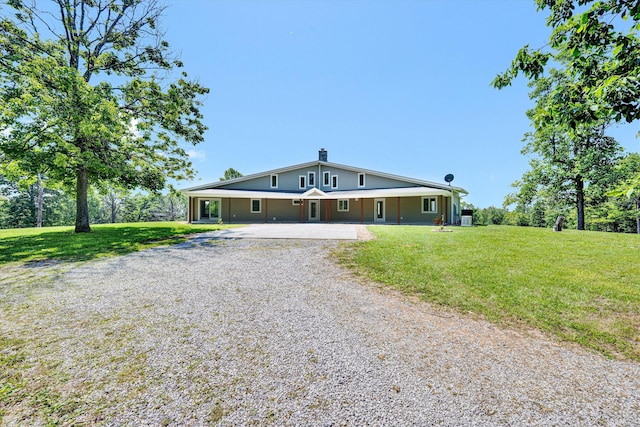 571 Cary Rd, Pilot, VA 24138 - view of front of house featuring gravel driveway, a front lawn, and a chimney