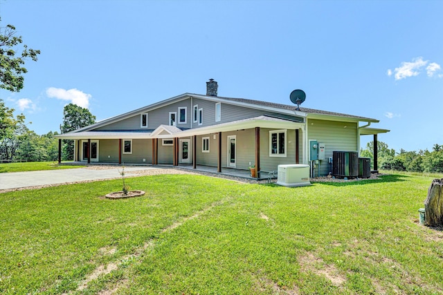 571 Cary Rd, Pilot, VA 24138 - rear view of house featuring a chimney, concrete driveway, and a yard