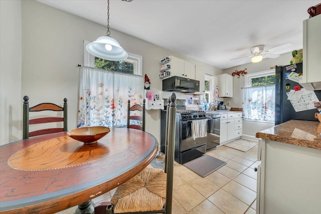 2728 Lansing Dr SW, Roanoke, VA 24015 - kitchen with black microwave, stainless steel dishwasher, gas range, freestanding refrigerator, and white cabinets