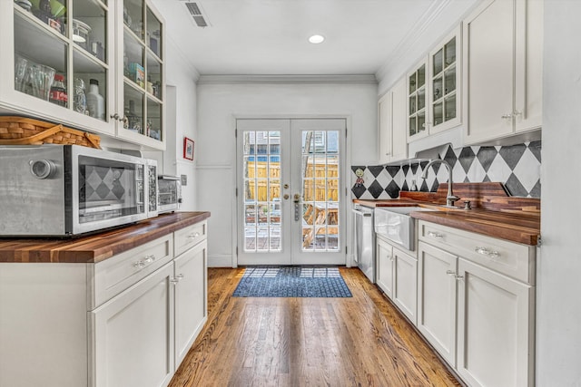 2410 Cornwallis Ave SE, Roanoke, VA 24014 - bar area featuring appliances with stainless steel finishes, backsplash, french doors, light wood-style floors, and crown molding