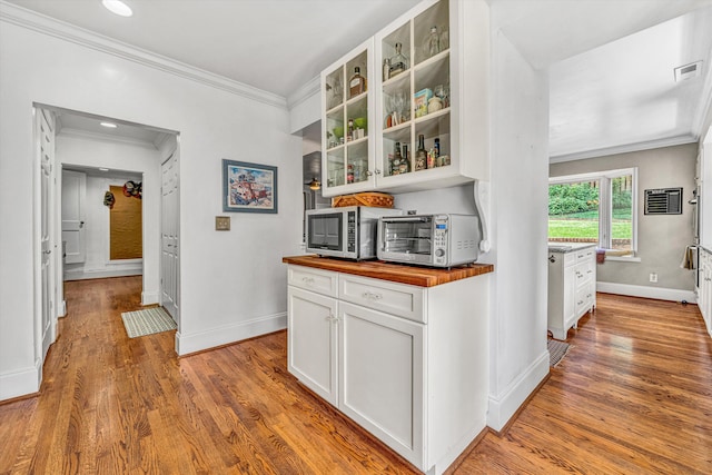 2410 Cornwallis Ave SE, Roanoke, VA 24014 - bar with stainless steel microwave, ornamental molding, and light wood-style flooring