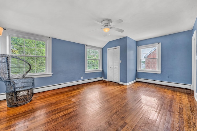 2410 Cornwallis Ave SE, Roanoke, VA 24014 - unfurnished bedroom featuring baseboard heating, a baseboard heating unit, wood finished floors, multiple windows, and lofted ceiling