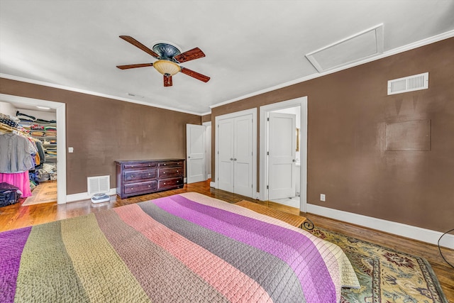 2410 Cornwallis Ave SE, Roanoke, VA 24014 - bedroom with attic access, wood finished floors, a ceiling fan, ornamental molding, and a closet