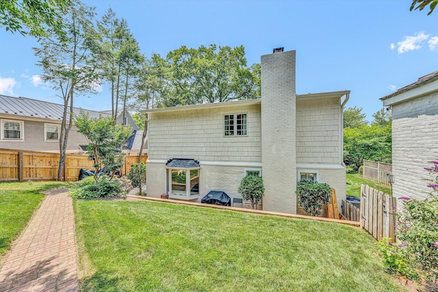 2410 Cornwallis Ave SE, Roanoke, VA 24014 - back of house with a chimney, a fenced backyard, and brick siding