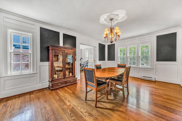 2410 Cornwallis Ave SE, Roanoke, VA 24014 - dining room with a decorative wall, a chandelier, crown molding, and wood finished floors