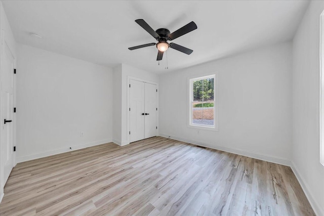 2365 Lakewood Forest Rd, Moneta, VA 24121 - unfurnished bedroom with light wood-style flooring, a ceiling fan, and a closet