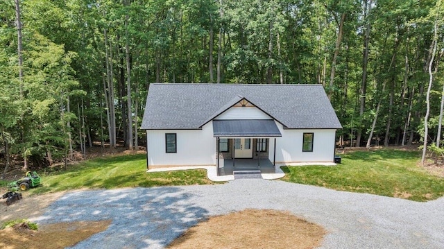 2365 Lakewood Forest Rd, Moneta, VA 24121 - view of front of property with gravel driveway, a front lawn, a forest view, and roof with shingles