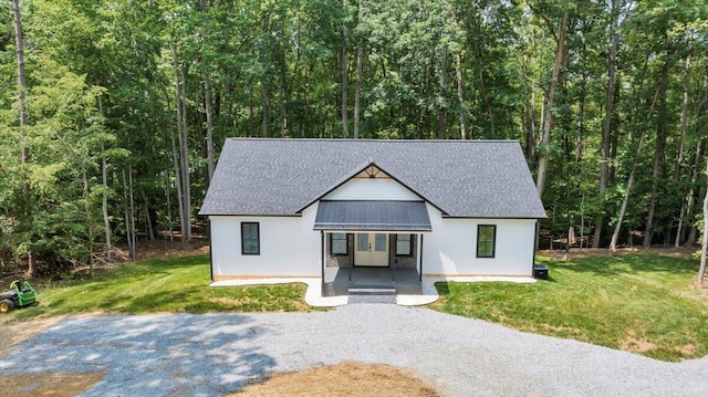 2365 Lakewood Forest Rd, Moneta, VA 24121 - view of front of home with a porch, a wooded view, a front yard, and a shingled roof