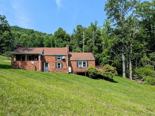 606 Haycock Rd SE, Floyd, VA 24091 - view of front of house with a chimney, a forest view, brick siding, and a front yard