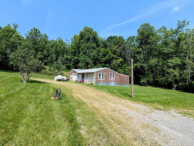 606 Haycock Rd SE, Floyd, VA 24091 - ranch-style home featuring a front lawn, a wooded view, and an outdoor structure