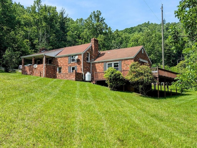 606 Haycock Rd SE, Floyd, VA 24091 - back of house with a chimney, a yard, a wooden deck, and brick siding