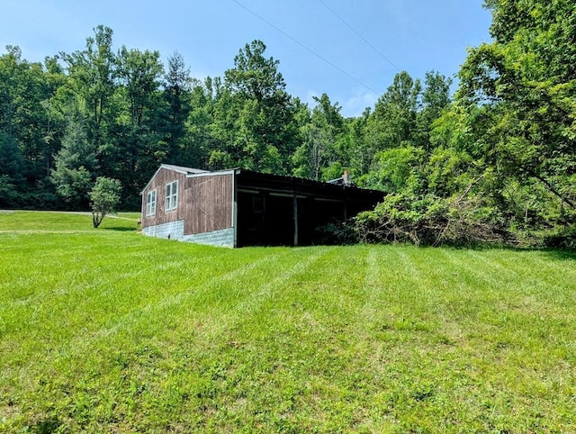 606 Haycock Rd SE, Floyd, VA 24091 - view of green lawn featuring an outdoor structure and a forest view