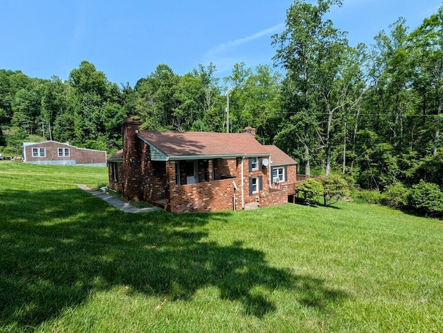 606 Haycock Rd SE, Floyd, VA 24091 - view of front of property featuring a chimney, a front yard, brick siding, and a wooded view