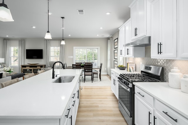 7059 Fairway Ridge Rd, Roanoke, VA 24018 - kitchen featuring stainless steel range with gas stovetop, under cabinet range hood, healthy amount of natural light, light countertops, and recessed lighting