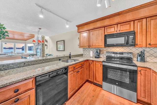 1230 Nature Ln Unit 1, Union Hall, VA 24176 - kitchen with black appliances, light wood-style flooring, a textured ceiling, and brown cabinetry