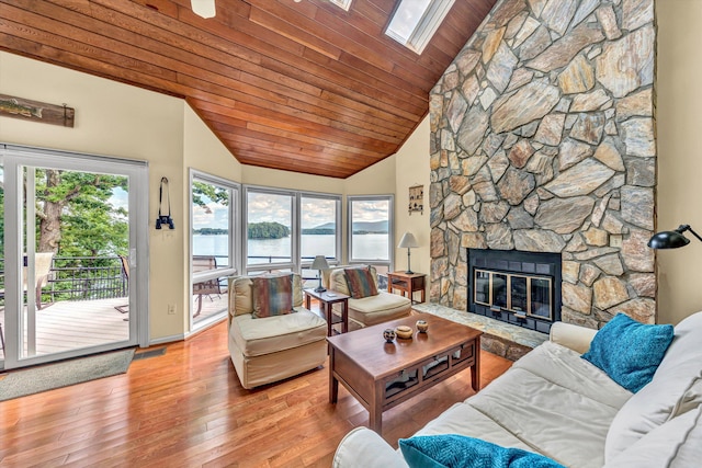 1230 Nature Ln Unit 1, Union Hall, VA 24176 - living room featuring wood ceiling, lofted ceiling, hardwood / wood-style floors, a water view, and a stone fireplace