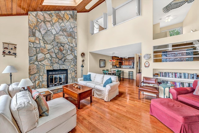 1230 Nature Ln Unit 1, Union Hall, VA 24176 - living area with light wood-style floors, a stone fireplace, crown molding, and a high ceiling