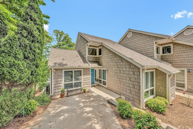 1230 Nature Ln Unit 1, Union Hall, VA 24176 - back of property featuring a shingled roof and a patio area