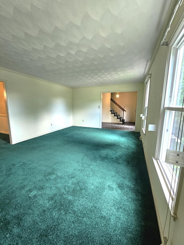 2633 Wood Warbler Ln, Roanoke, VA 24018 - unfurnished living room featuring stairs, healthy amount of natural light, a textured ceiling, and dark carpet