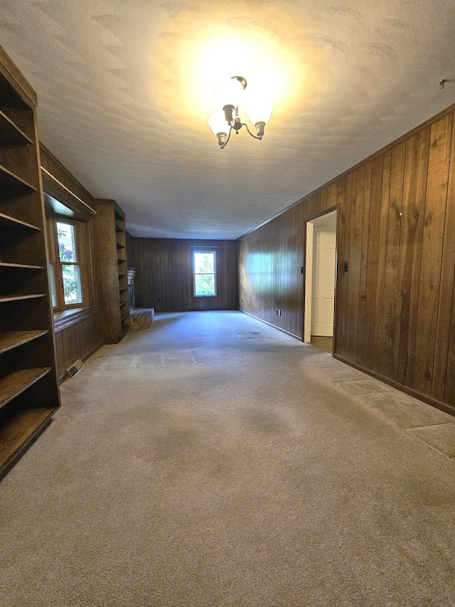 2633 Wood Warbler Ln, Roanoke, VA 24018 - unfurnished living room with wood walls and carpet flooring