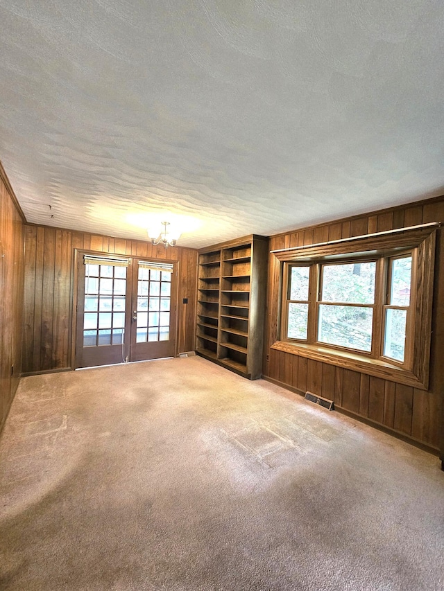 2633 Wood Warbler Ln, Roanoke, VA 24018 - carpeted spare room with wooden walls, a textured ceiling, a chandelier, and built in shelves