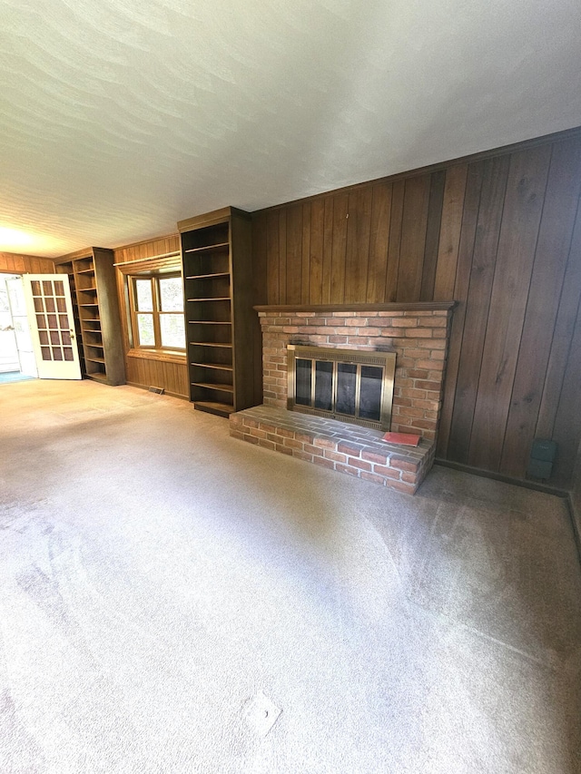 2633 Wood Warbler Ln, Roanoke, VA 24018 - unfurnished living room featuring a fireplace, wood walls, and carpet