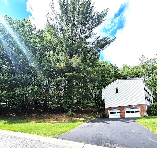 2633 Wood Warbler Ln, Roanoke, VA 24018 - view of home's exterior with driveway, brick siding, and a garage
