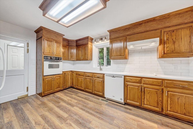 112 Sedgefield Ln, Vinton, VA 24179 - kitchen featuring white appliances, brown cabinets, backsplash, and light countertops