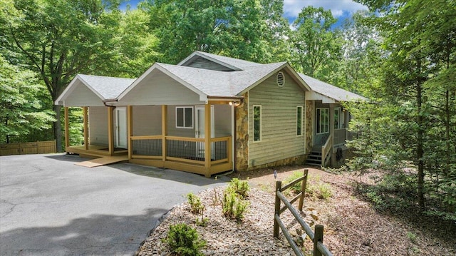 112 Sedgefield Ln, Vinton, VA 24179 - view of front of home featuring roof with shingles, a porch, and view of wooded area