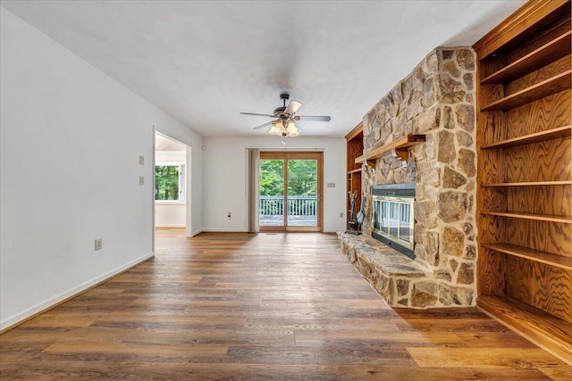 112 Sedgefield Ln, Vinton, VA 24179 - unfurnished living room featuring a ceiling fan, wood finished floors, and a stone fireplace