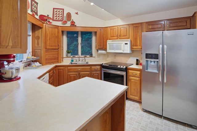126 Windmere Trl, Moneta, VA 24121 - kitchen featuring appliances with stainless steel finishes, lofted ceiling, light countertops, brown cabinetry, and a peninsula