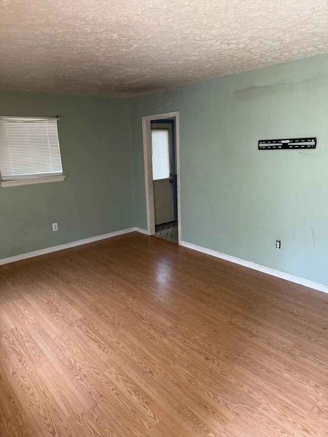919 Glenn Ridge Rd NW, Roanoke, VA 24017 - spare room featuring a textured ceiling and wood finished floors