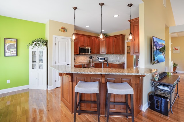 414 Augusta Way, Wirtz, VA 24184 - kitchen with appliances with stainless steel finishes, light stone counters, a kitchen bar, a peninsula, and backsplash