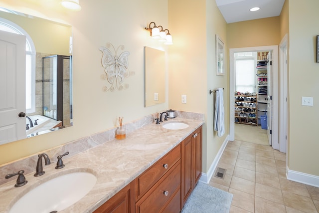 414 Augusta Way, Wirtz, VA 24184 - bathroom featuring a stall shower, double vanity, a walk in closet, and tile patterned flooring