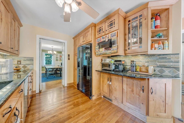 2702 Yellow Mountain Rd SE, Roanoke, VA 24014 - kitchen featuring decorative backsplash, light wood-style floors, dark stone counters, glass insert cabinets, and a ceiling fan