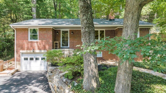 2702 Yellow Mountain Rd SE, Roanoke, VA 24014 - ranch-style home with an attached garage, brick siding, driveway, a chimney, and roof with shingles