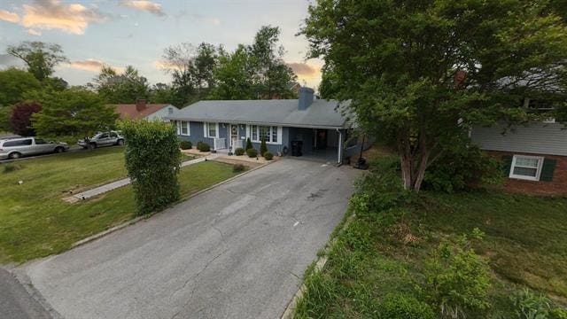3325 Fleetwood Ave SW, Roanoke, VA 24015 - ranch-style home featuring asphalt driveway, a chimney, a yard, and a carport