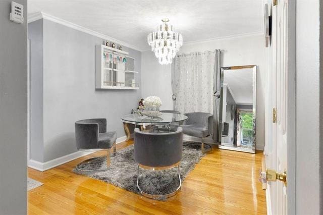 3325 Fleetwood Ave SW, Roanoke, VA 24015 - living area featuring wood finished floors, ornamental molding, and a chandelier