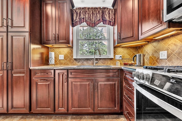 716 Arcadia Cir, Vinton, VA 24179 - kitchen featuring stainless steel appliances, light stone countertops, tasteful backsplash, and reddish brown cabinets