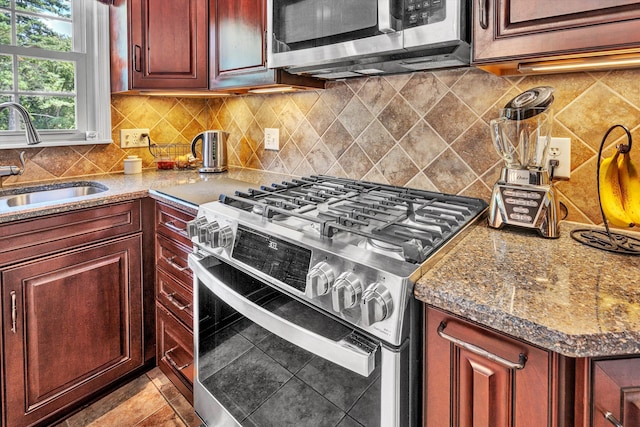 716 Arcadia Cir, Vinton, VA 24179 - kitchen featuring appliances with stainless steel finishes, decorative backsplash, stone counters, and reddish brown cabinets