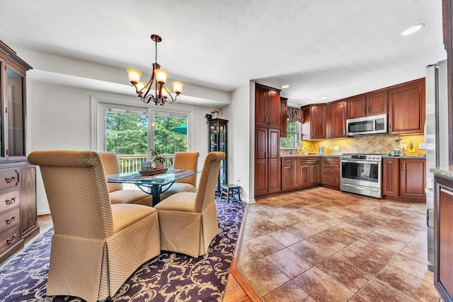 716 Arcadia Cir, Vinton, VA 24179 - kitchen with stainless steel appliances, a chandelier, healthy amount of natural light, decorative backsplash, and recessed lighting